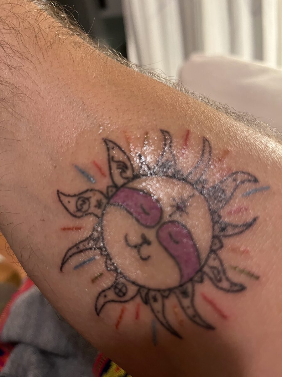 Cosmic sloth tattoo on Yanik's right arm