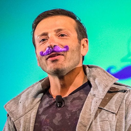 Yanik on stage with a purple mustache