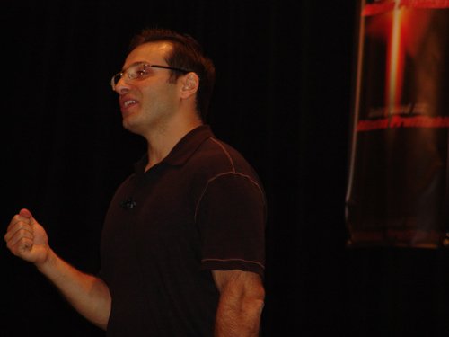 Yanik on stage, mid presentation