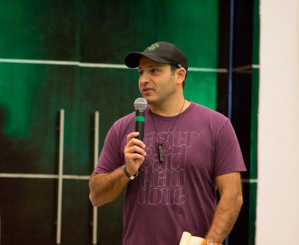 Yanik speaking casually to a room