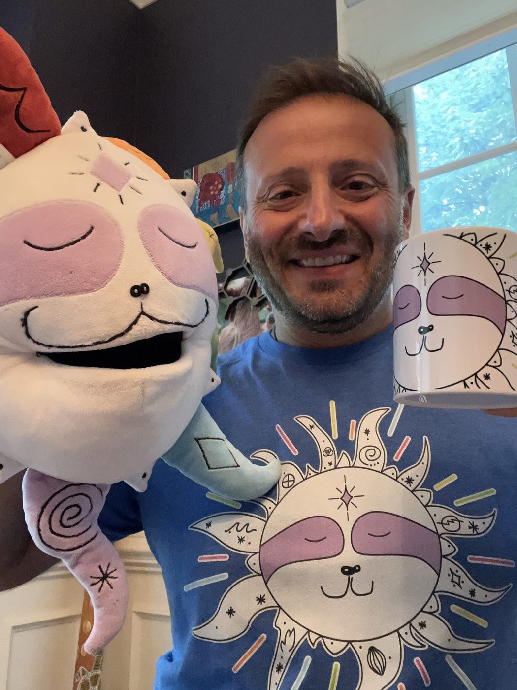 Yanik holding two sun plushies